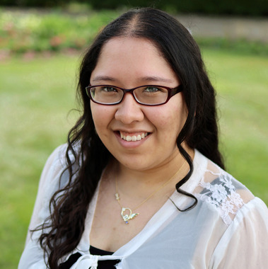 A portrait of Emily Perez smiling at the camera. 