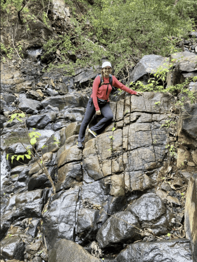 Sarah Gonzalez leans on rocks.