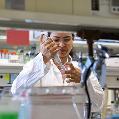 Dr. Aathmaja Anandhi Rangarajan works at her lab bench.