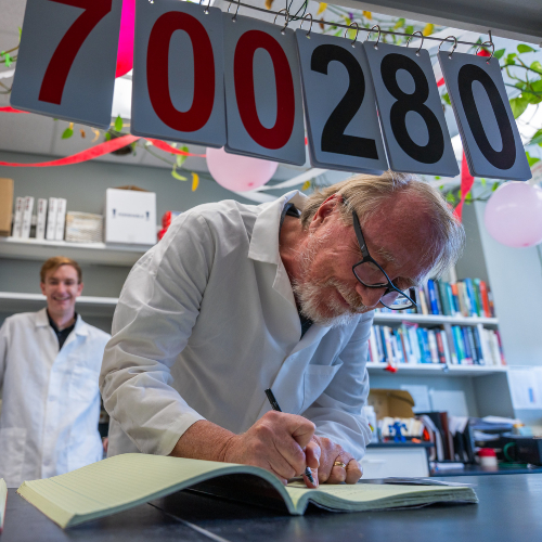Rich Lenski adds to the Long-Term Evolution Experiment lab notebook during the reboot of the experiment in 2025.