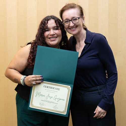 Dr. Gemma Reguera and graduate student Maria Guzman smile with Maria's award certificate.