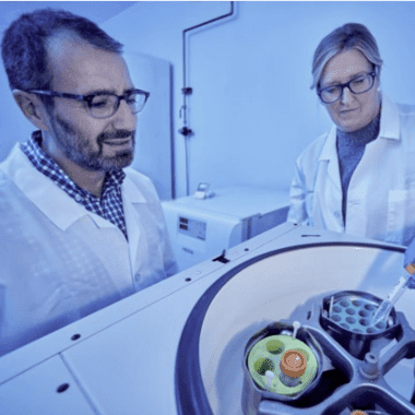 Dr. Rob Abramovitch and a volunteer work with lab equipment.