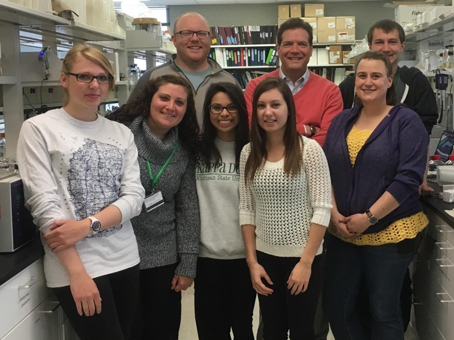 A group of photo stand together in a lab.