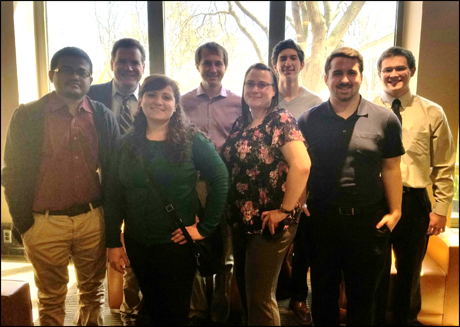 A group of people smile at the camera.