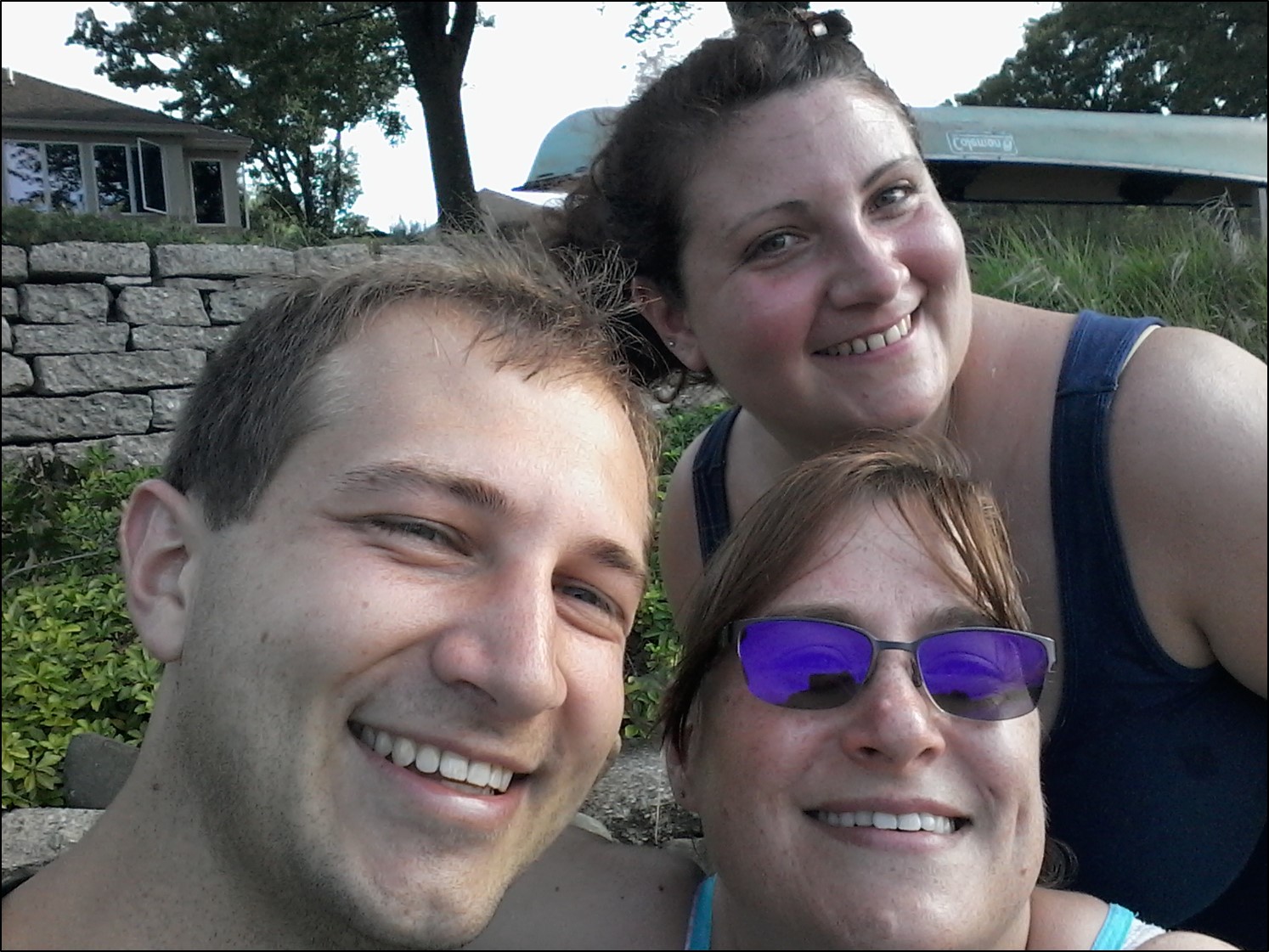 Three people smile at the camera.