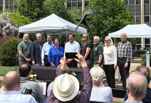 Eight MMG faculty members retiring from MSU posing with the department chair after the retirement ceremony.