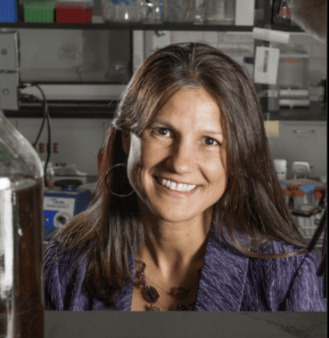 Shannon Manning smiles at the camera. She's in a lab.